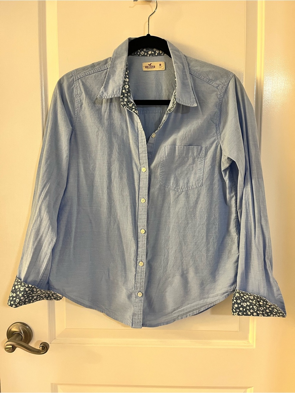 Hollister blue button-up shirt with floral print on collar and cuffs
